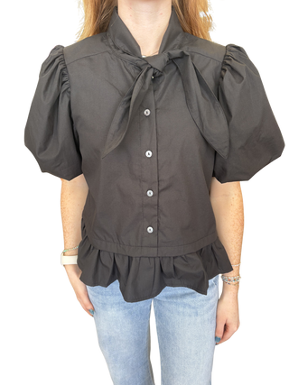 Solid short sleeve top featuring bow and ruffle detail