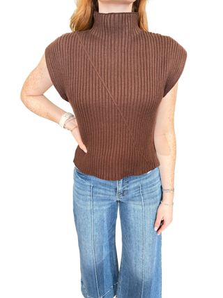 Solid cap sleeve knit top featuring ribbed texture. Mock neckline