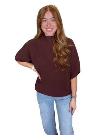 Solid mock neck short sleeve sweater knit top featuring dolman sleeves