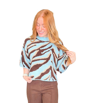 Animal print short sleeve sweater top with a round neckline and exposed seam
