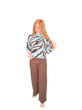 Animal print short sleeve sweater top with a round neckline and exposed seam