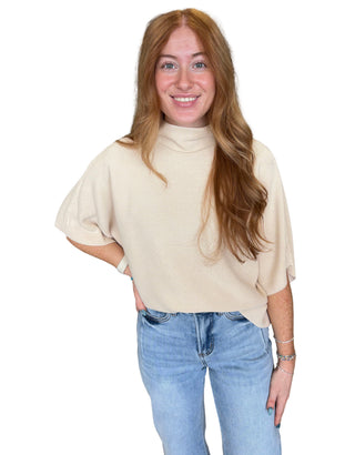 Solid mock neck short sleeve sweater knit top featuring dolman sleeves