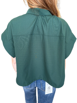 Solid short sleeve top featuring stand neck and button closure at front