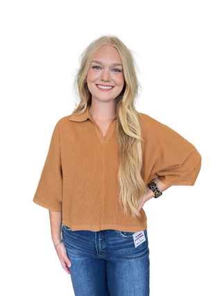 Solid 3/4 sleeve knit top featuring open V-neck collar