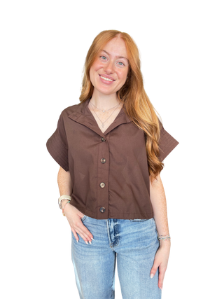 Solid short sleeve top featuring stand neck and button closure at front