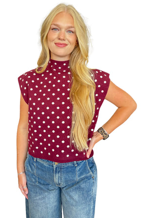 Polka dot mock neck sleeveless top featuring cap sleeve detail