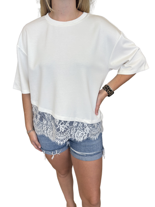 Solid short sleeve knit top featuring scallop lace hem detail