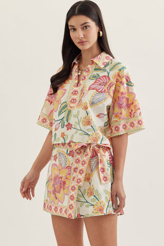 Botanical print short sleeve top featuring split V-neck collar