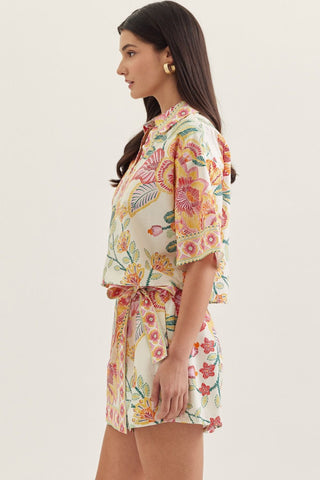 Botanical print short sleeve top featuring split V-neck collar