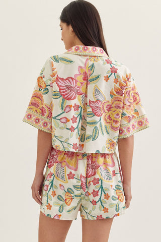 Botanical print short sleeve top featuring split V-neck collar
