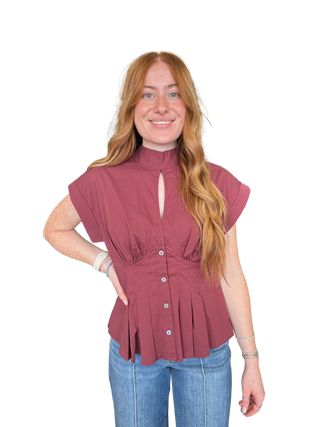 Solid ¾ puff sleeve top featuring V-neck and bow tie detail