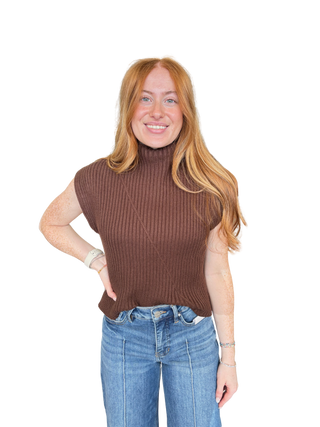 Solid cap sleeve knit top featuring ribbed texture. Mock neckline
