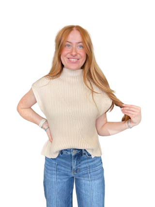 Solid cap sleeve knit top featuring ribbed texture. Mock neckline