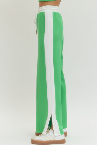 Solid wide leg knit pants featuring elastic waistband with drawstring.