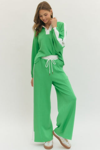 Solid wide leg knit pants featuring elastic waistband with drawstring.