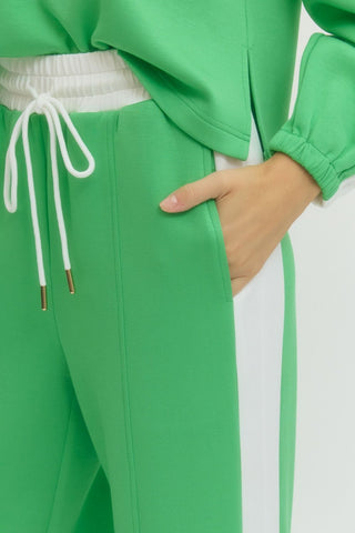 Solid wide leg knit pants featuring elastic waistband with drawstring.