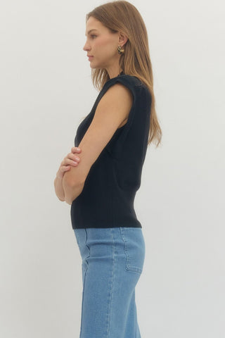 Solid mock neck sleeveless knit top featuring ribbed hem