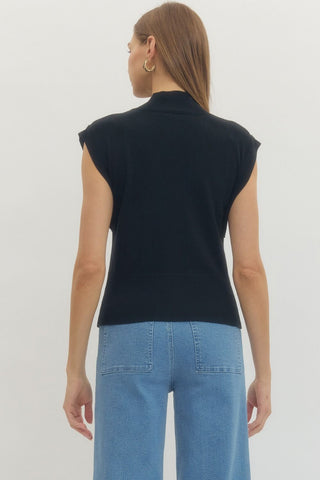 Solid mock neck sleeveless knit top featuring ribbed hem