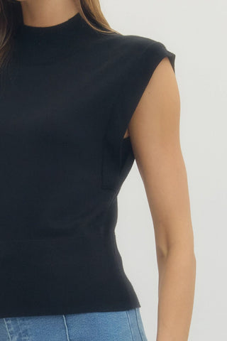 Solid mock neck sleeveless knit top featuring ribbed hem