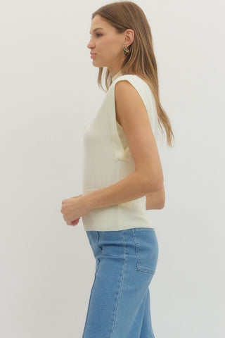 Solid mock neck sleeveless knit top featuring ribbed hem