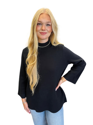 Solid mock neck 3/4 sleeve top featuring straight hem.