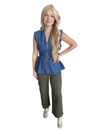 sleeveless peplum top featuring wide smocked waist and zipper