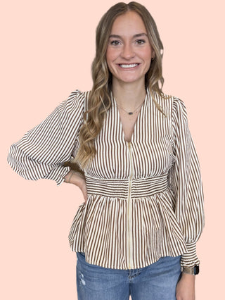 Stripe print long sleeve peplum top featuring smocked waistband and V-neck