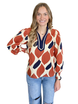 Geometric print long sleeve top featuring contrast split neck