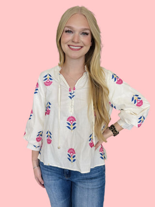 Botanical embroidered 3/4 puff sleeve top featuring ruffle neck detail