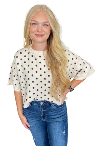 Polka dot round neck short sleeve sweater knit top featuring ribbed trim