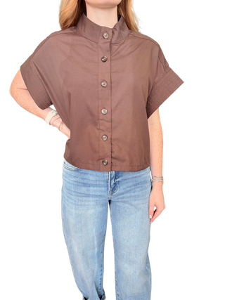 Solid short sleeve top featuring stand neck and button closure at front
