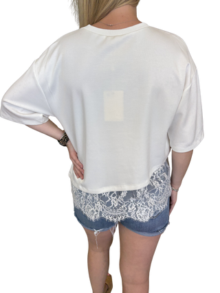 Solid short sleeve knit top featuring scallop lace hem detail