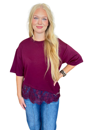 Solid short sleeve knit top featuring scallop lace hem detail