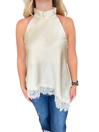 Solid sleeveless high neck top featuring asymmetric lace hem