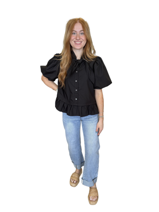 Solid short sleeve top featuring bow and ruffle detail