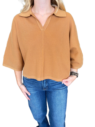 Solid 3/4 sleeve knit top featuring open V-neck collar