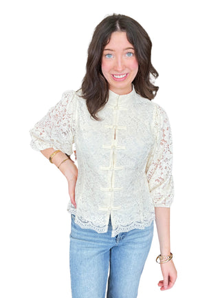 Lace ¾ balloon sleeve top with a stand collar and frog button closure
