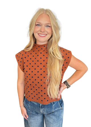 Polka dot mock neck sleeveless top featuring cap sleeve detail